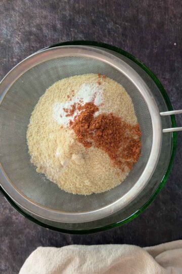 Sifting flour, cinnamon, and baking soda for banana bread batter.