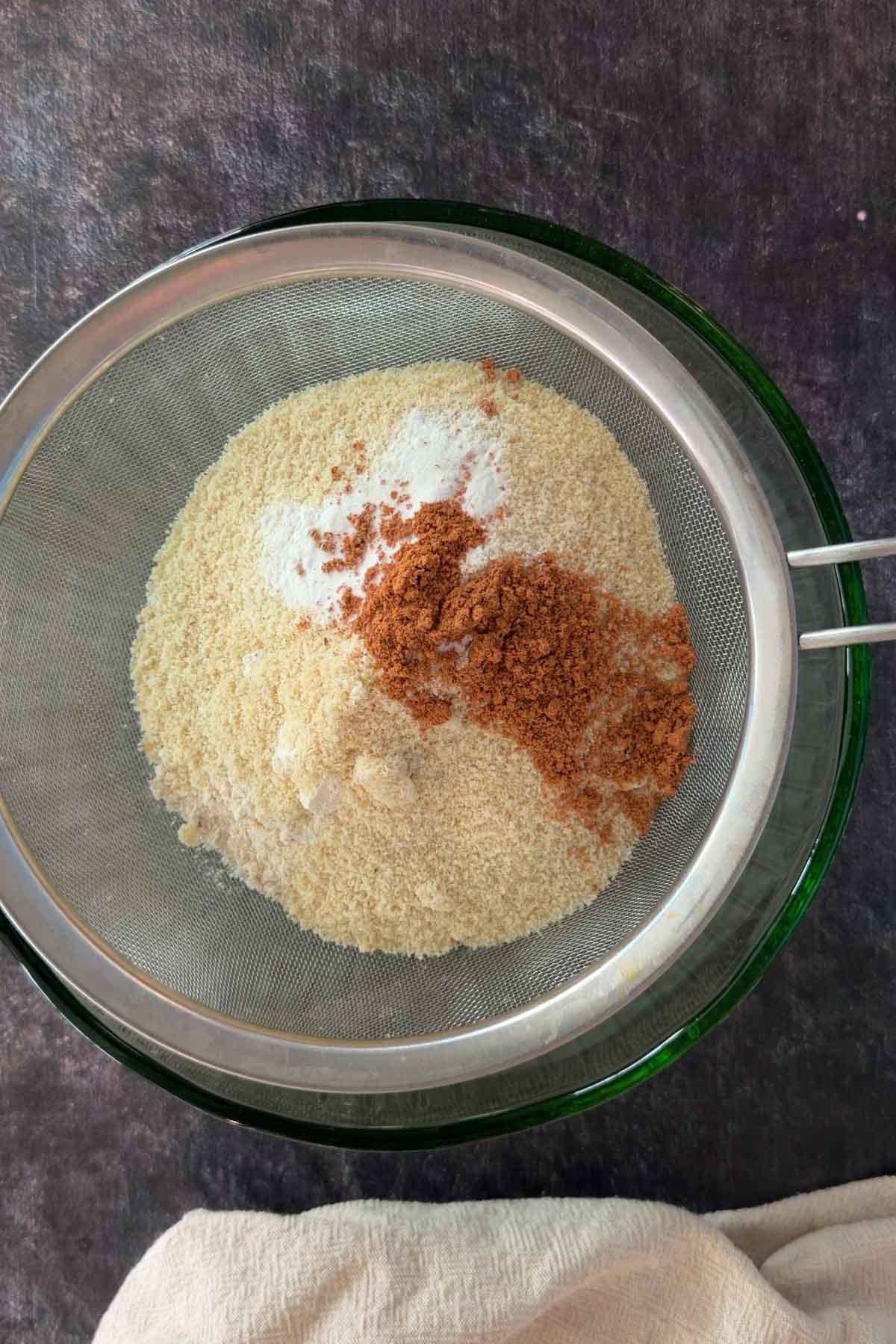 Sifting flour, cinnamon, and baking soda for banana bread batter.
