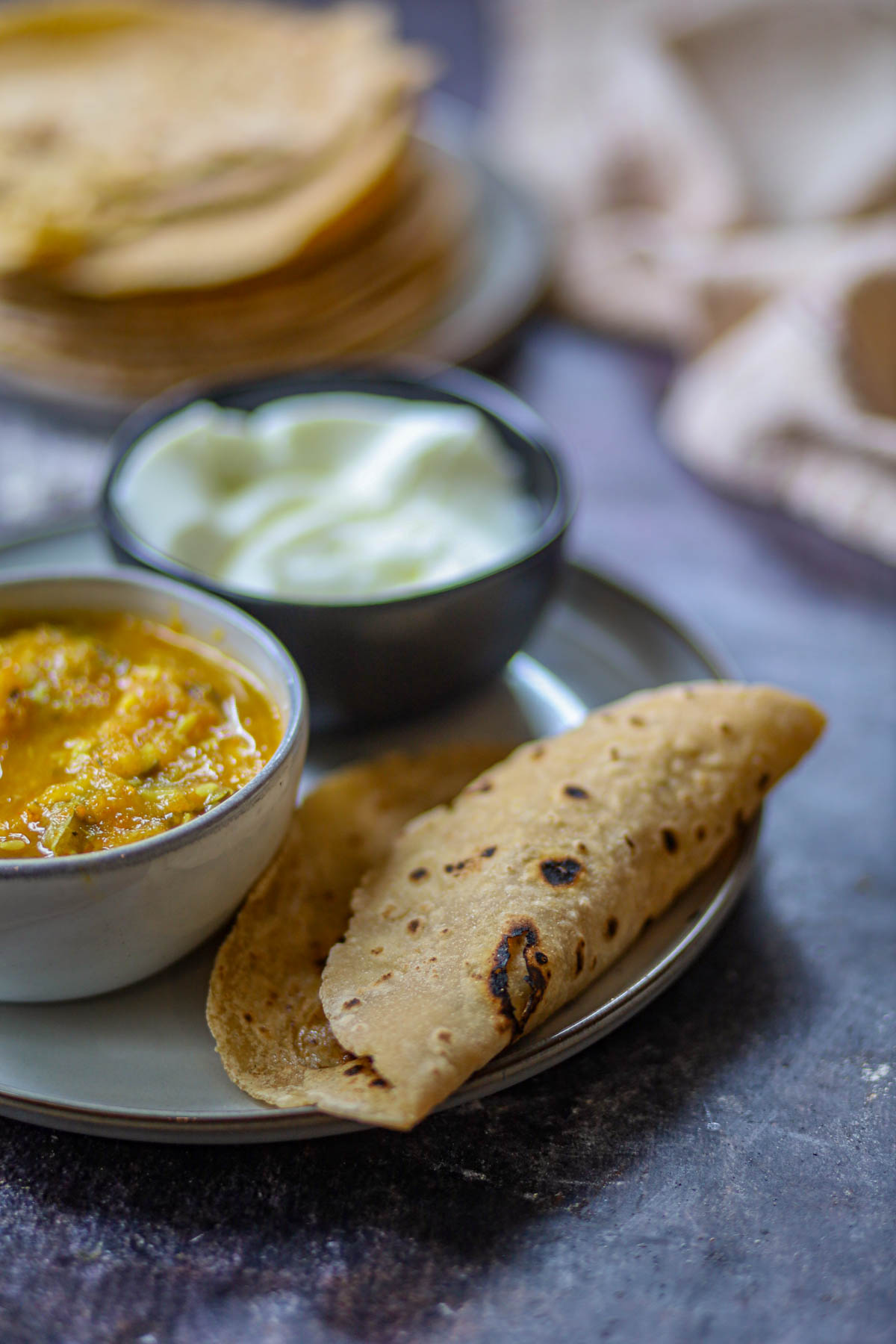 Tofu roti served with curry and yogurt.